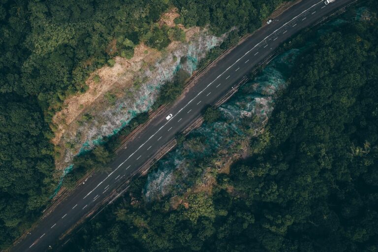 Drone shot of a winding road through lush forest in Kijal, Terengganu, Malaysia.